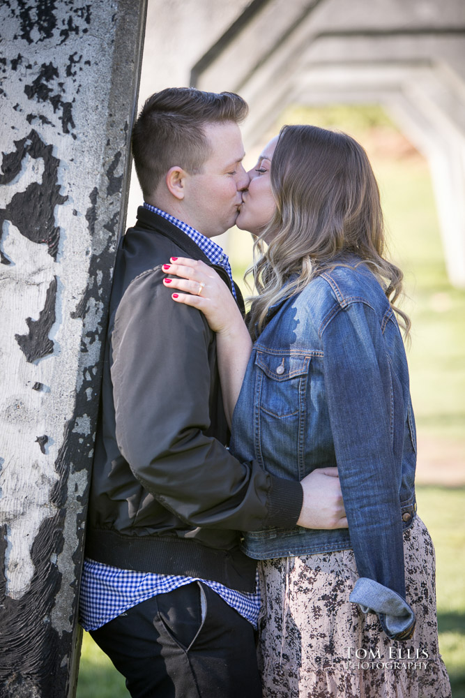Couple shars a kiss during their engagement photo session at Gas Works Park