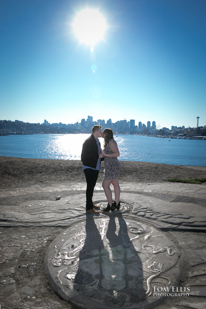 Kate and Kevin kiss at the top of the Kite Hill during their engagement photo session at Gas Works Park