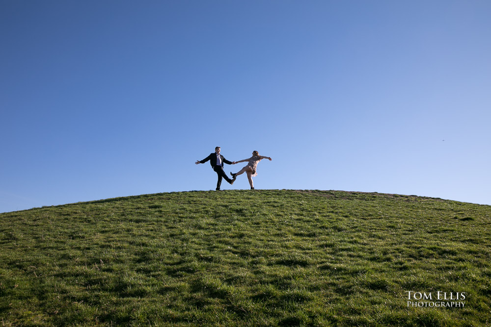 Kate and Kevin dance at the top of the Kite Hill during their engagement photo session at Gas Works Park