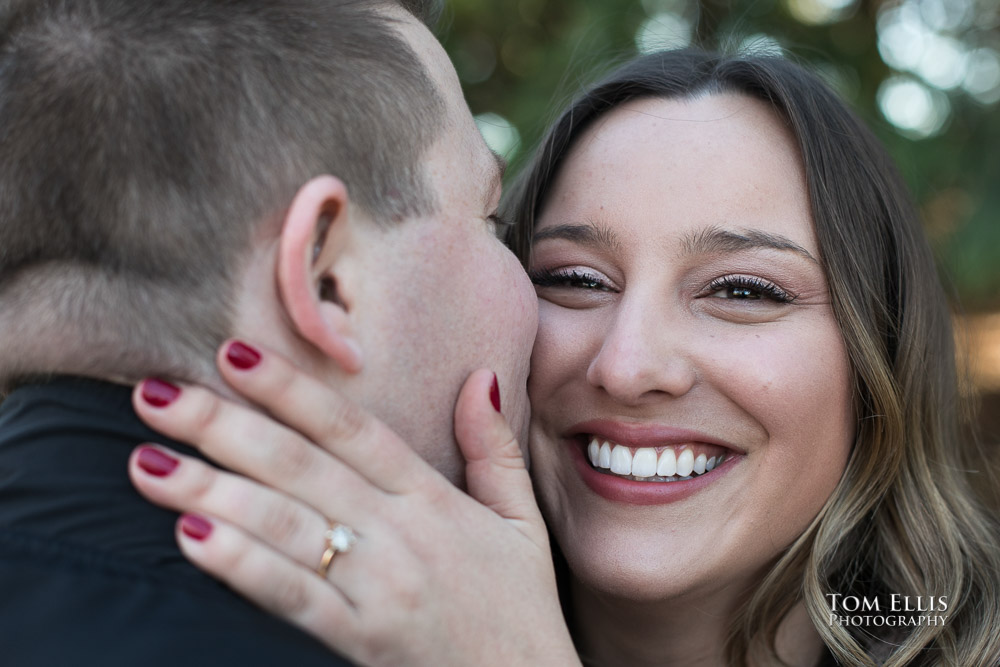 Close up of Kate and she gets a kiss from Kevin during their engagement photo session at Gas Works Park