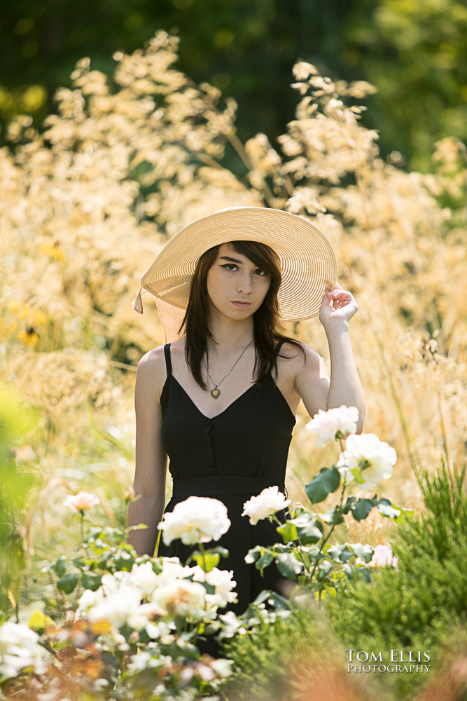 Beautiful high school senior girl among flowers during her senior photo session at Bellevue Botanical Gardens