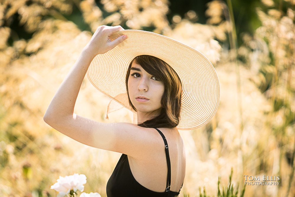 close up photo of Beautiful high school senior girl in a flower bed during her senior photo session at Bellevue Botanical Gardens