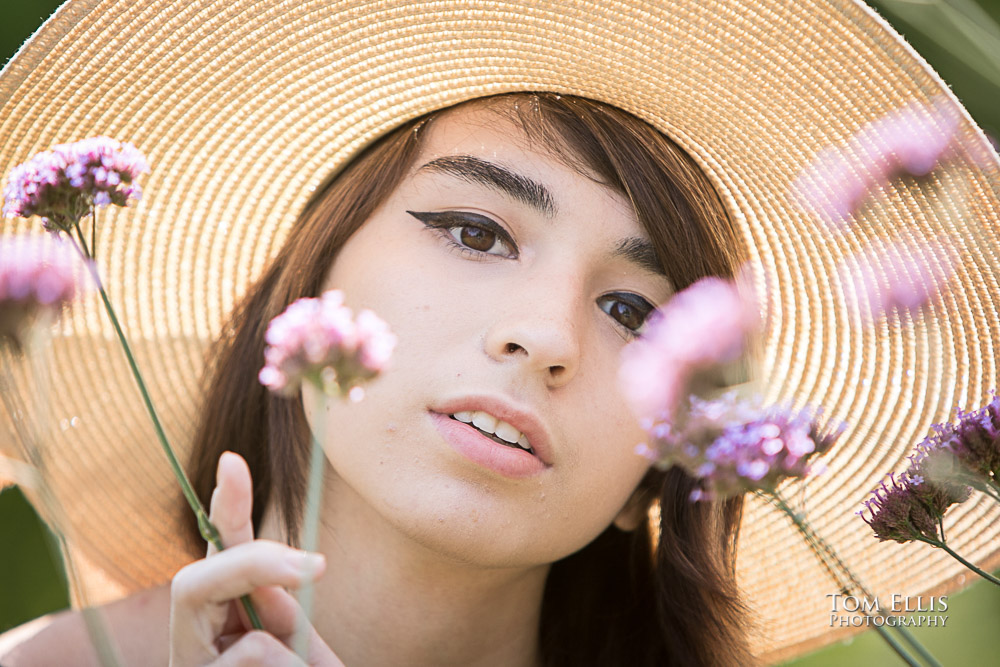 Very close up photo of Beautiful high school senior girl in a cool hat during her senior photo session at Bellevue Botanical Gardens
