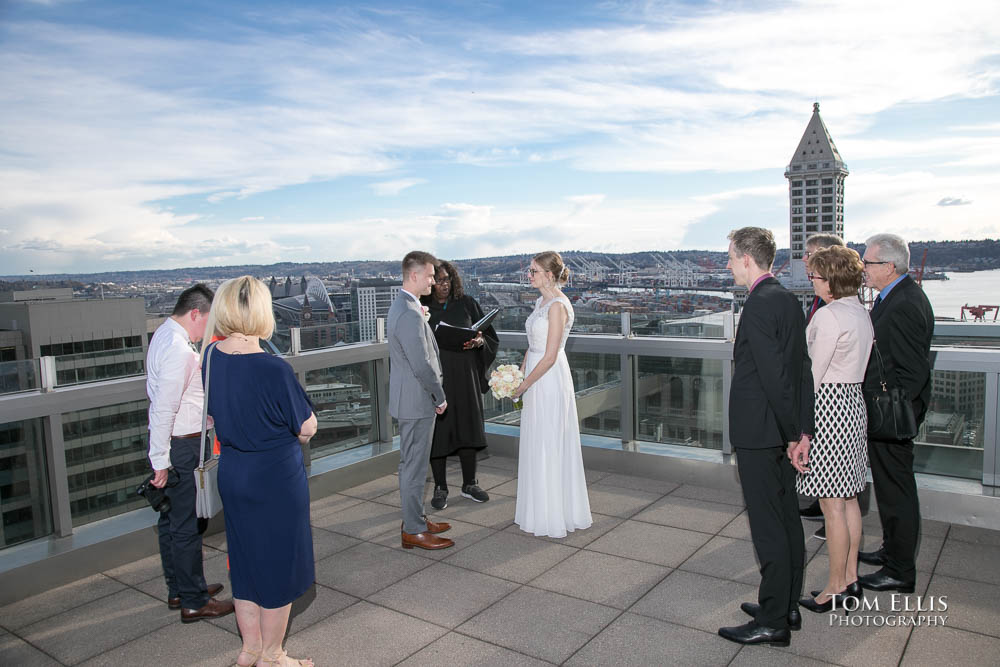 Elopement wedding ceremony on the rooftop balcony of the Seattle Courthouse. Tom Ellis Photography, premier Seattle wedding photographer