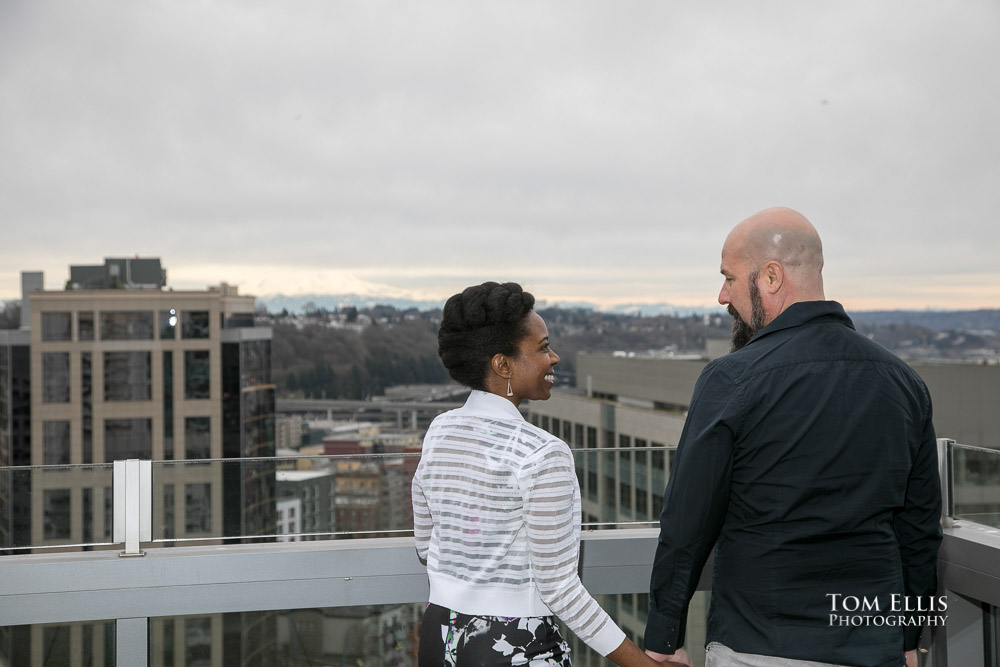 Couple stand on the balcony before their elopement wedding at the Seattle Courthouse. Tom Ellis Photography, top rated Seattle wedding photographer