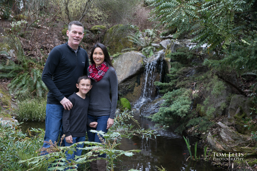Elaina, Trip and Jonathan pose near a waterfall during our Seattle area engagement photo session at the Bellevue Botanical Garden