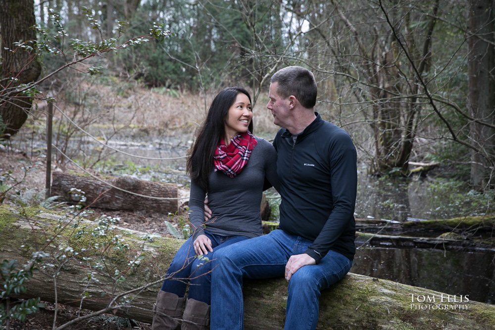 Elaina and Trip take a break near a pond during our Seattle area engagement photo session at the Bellevue Botanical Garden