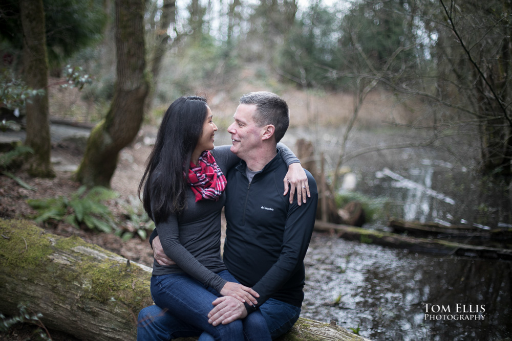 Elaina and Trip take a break near a pond during our Seattle area engagement photo session at the Bellevue Botanical Garden