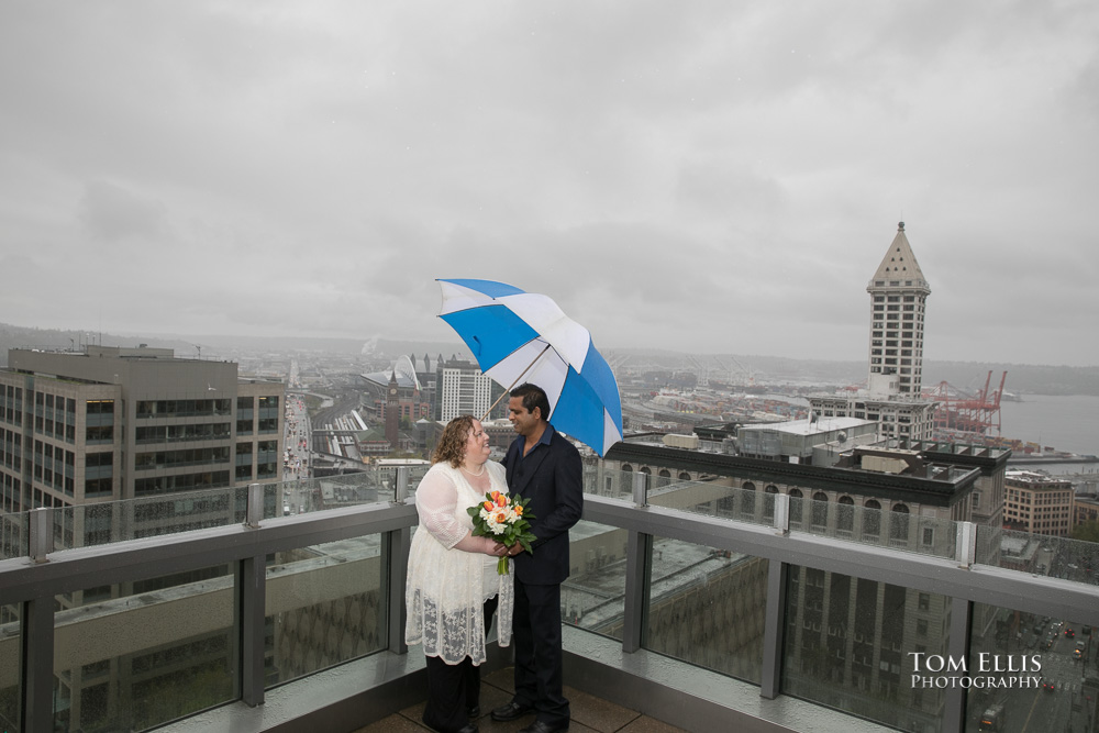 Bride and groom on the rooftop balcony at the Seattle Courthouse after their elopement wedding ceremony