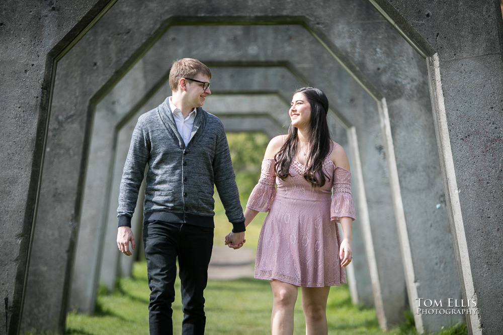 Yoshimi and Jake walk together during their engagement photo session at Gas Works Park