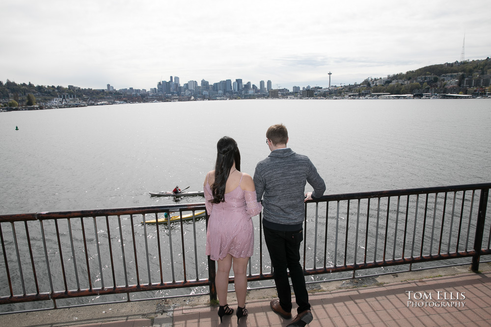 Yoshimi and Jake look out over Lake Union during their engagement photo session at Gas Works Park
