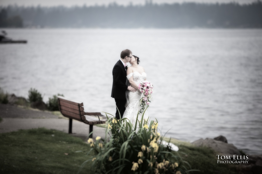 Bride and groom kiss on the shore of Lake Washington during their pre-ceremony photo session. Tom Ellis Photography, Seattle wedding photographer