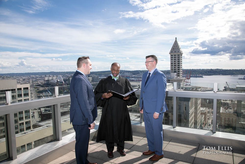 Same sex couple John and Terry get married on the rooftop balcony at the Seattle Courthouse. Tom Ellis Photography