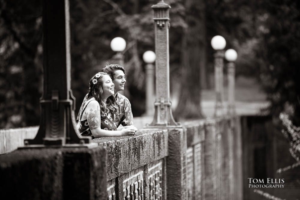 B&W photo of Aimee and Jordan on the pedestrian bridge during their Seattle engagement photo session at the Washington Arboretum