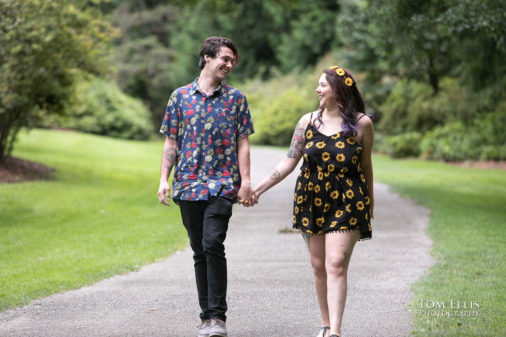 Engaged couple Aimee and Jordan stroll hand in hand through the Washington Arboretum during their Seattle engagement photo session