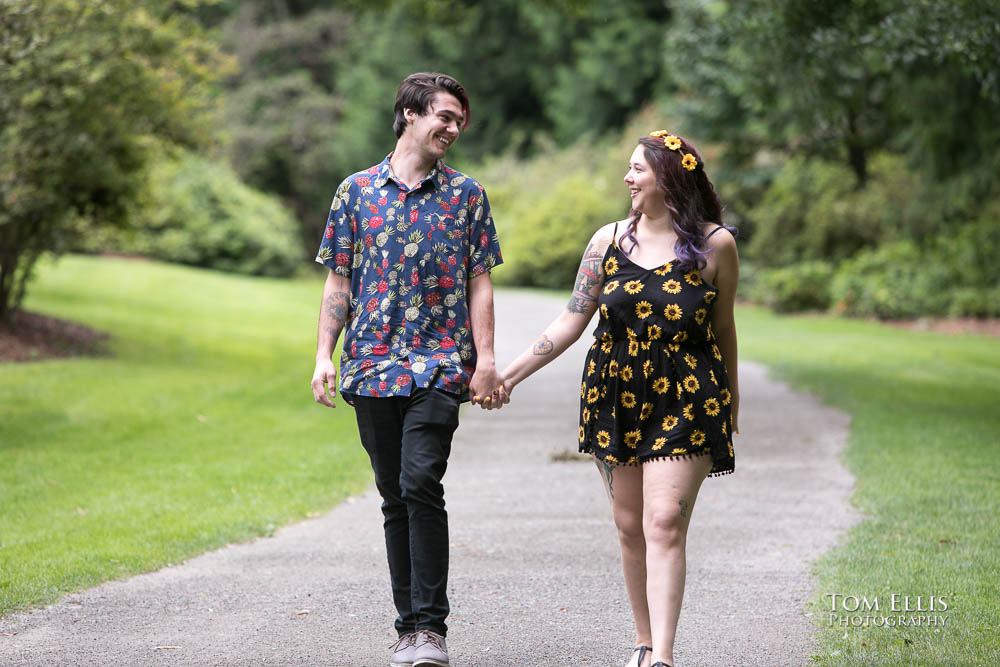 Engaged couple Aimee and Jordan stroll hand in hand through the Washington Arboretum during their Seattle engagement photo session