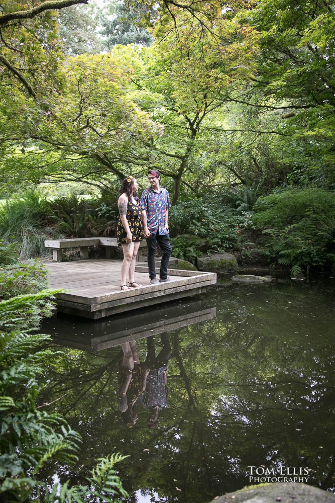 Aimee and Jordan reflected in a pond during their Seattle engagement photo session at the Washington Arboretum