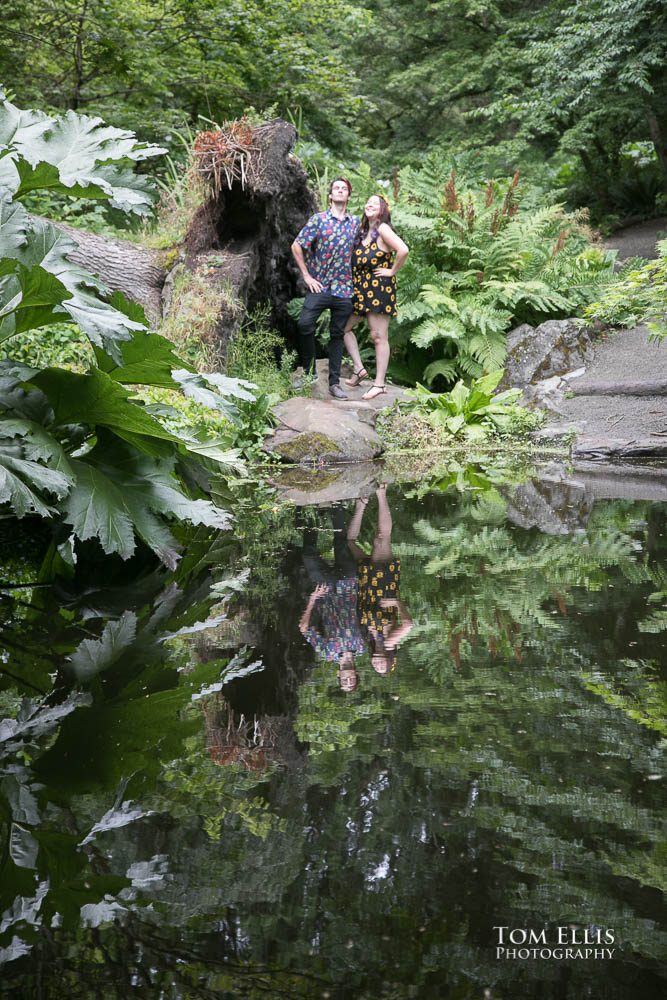 Newly engaged couple Aimee and Jordan pose near a pond on the Washington Arboretum during our engagement photo session.