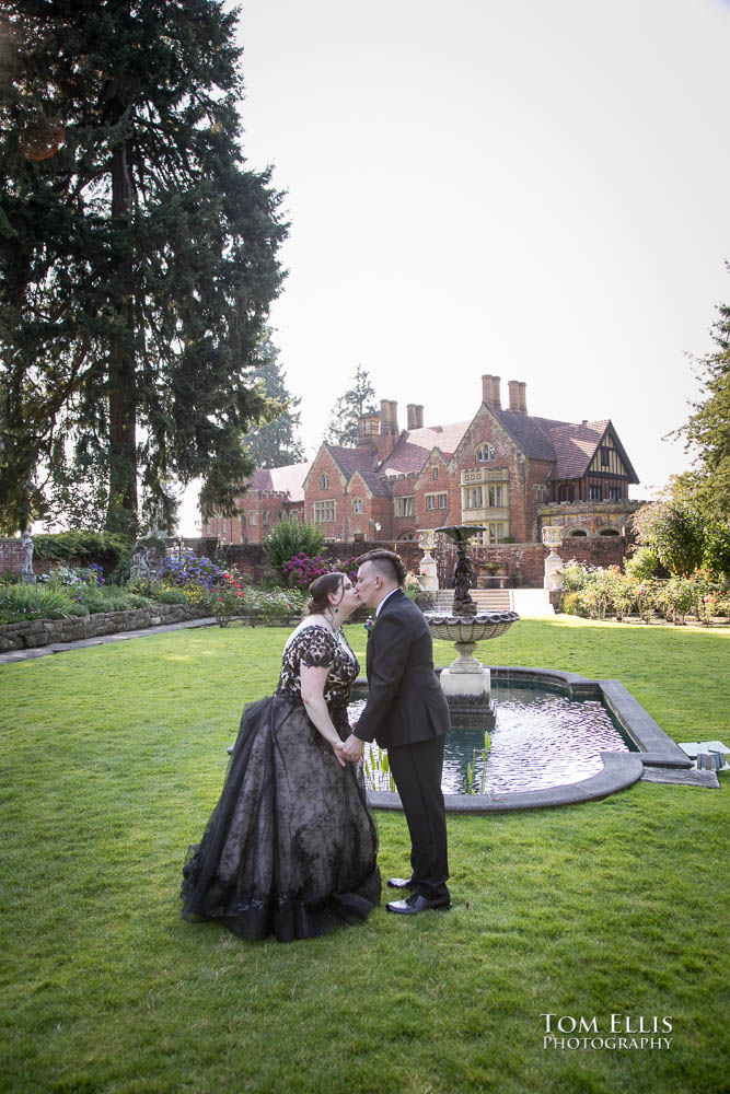 Bride and groom kiss in the formal garden after their wedding ceremony at Thornewood Castle. Tom Ellis Photography, destination wedding photographer