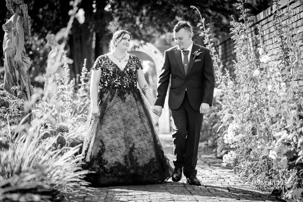 Mike and Lisa stroll through the formal garden at Thornewood Castle shortly before their wedding ceremony. Tom Ellis Photography