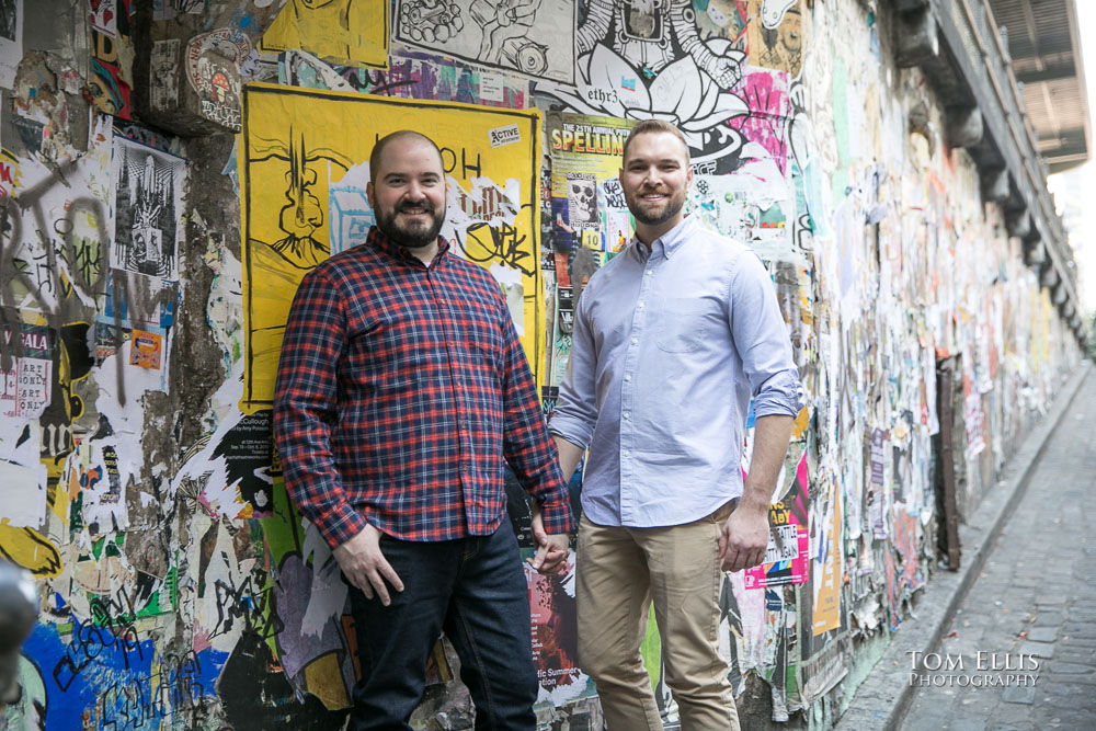 Same sex couple Mike and Ryan at Pike Place Market during their Seattle engagement photo session. Tom Ellis Photography, Seattle engagement photographer