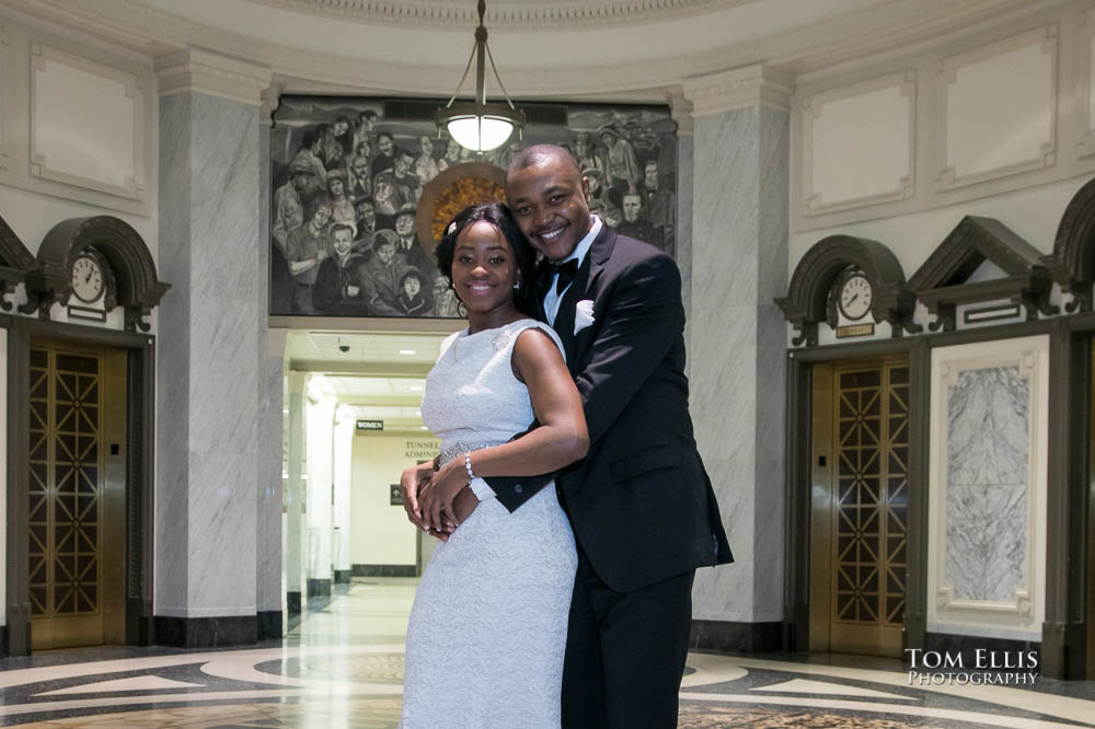African-American couple poses for a photo inside the King County Courthouse before their Seattle elopement wedding. Tom Ellis Photography, Seattle courthouse wedding photographer