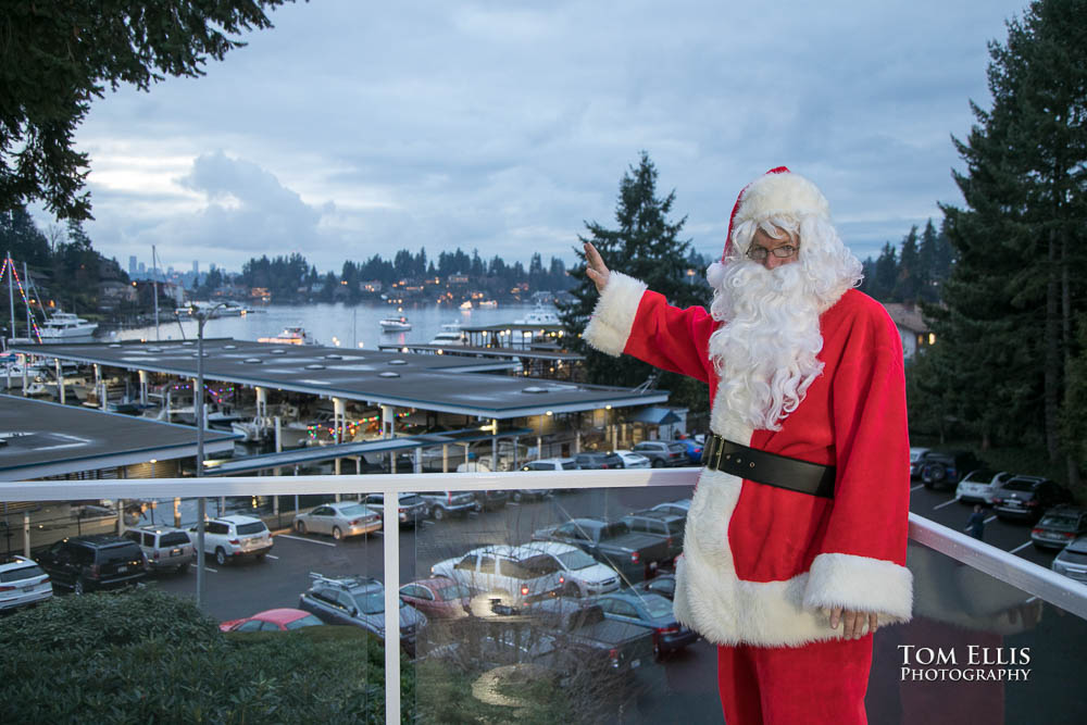 Santa on the deck at Meydenbauer Yacht club pointing at the boats returning from the Holiday Cruise. Tom Ellis Photography, Seattle event photographer