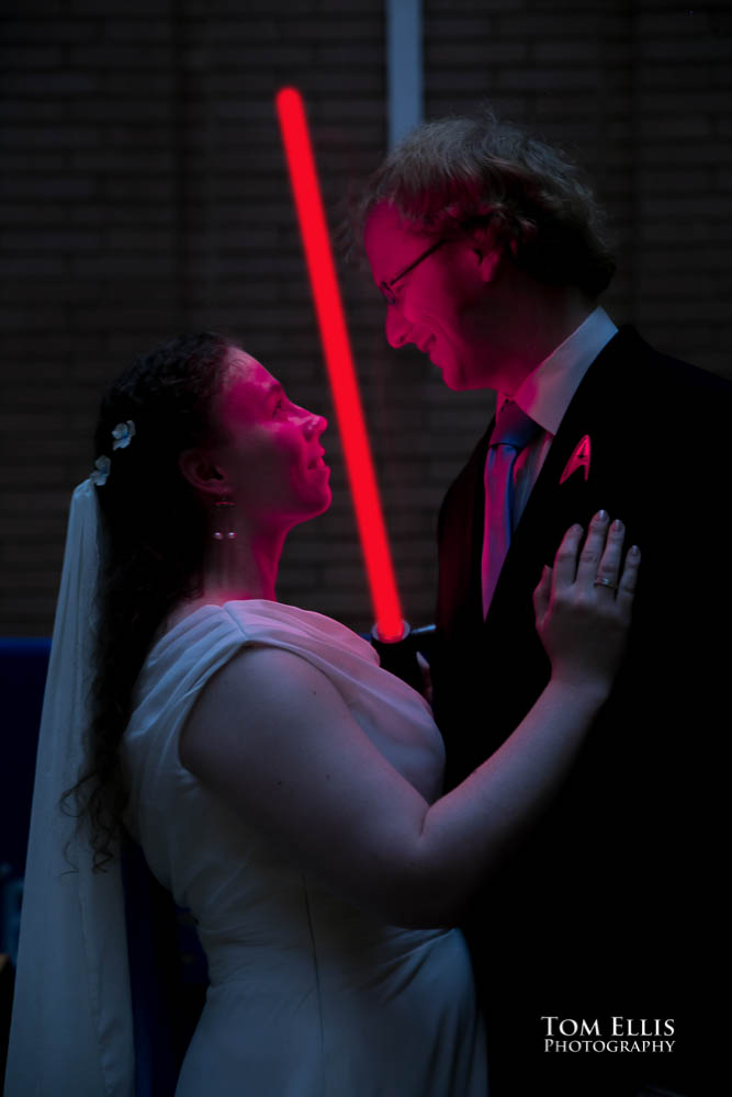 Bride and groom with lightsaber. Fantastic fantasy and science fiction HTTYD wedding - Tom Ellis Photography, Seattle wedding photographer