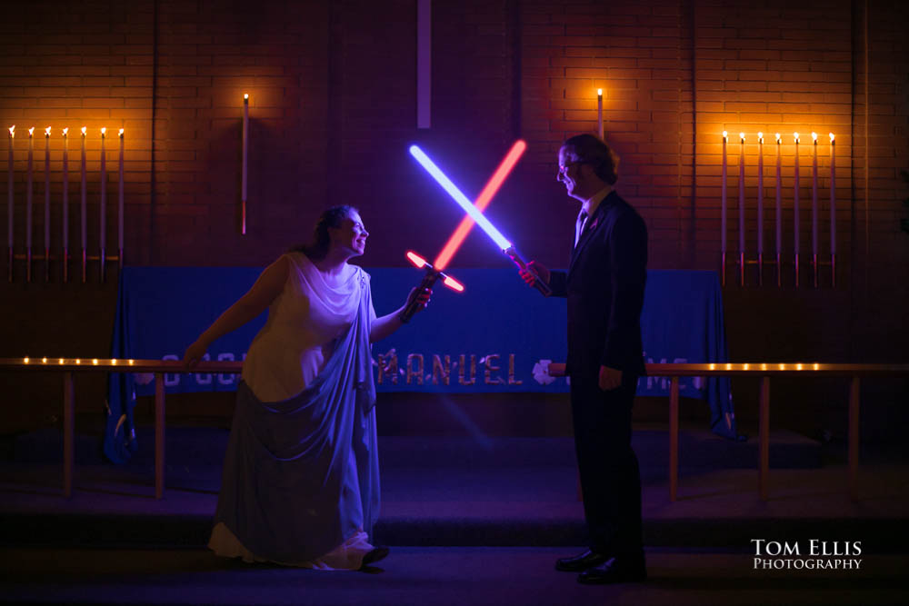 Bride and groom with lightsabers. Fantastic fantasy and science fiction HTTYD wedding - Tom Ellis Photography, Seattle wedding photographer