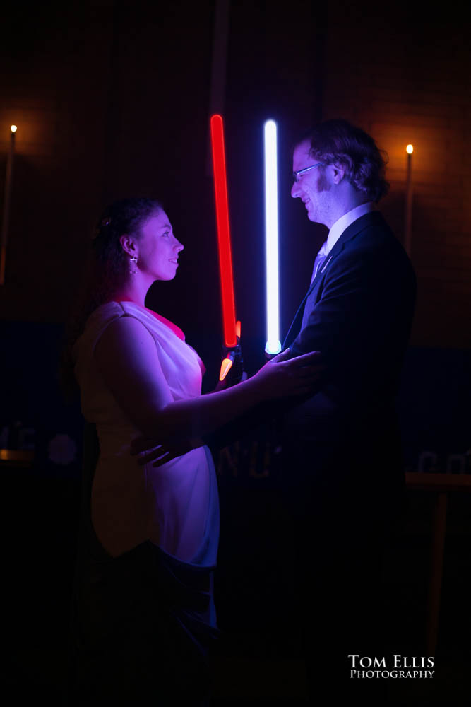 Bride and groom with lightsabers. Fantastic fantasy and science fiction HTTYD wedding - Tom Ellis Photography, Seattle wedding photographer