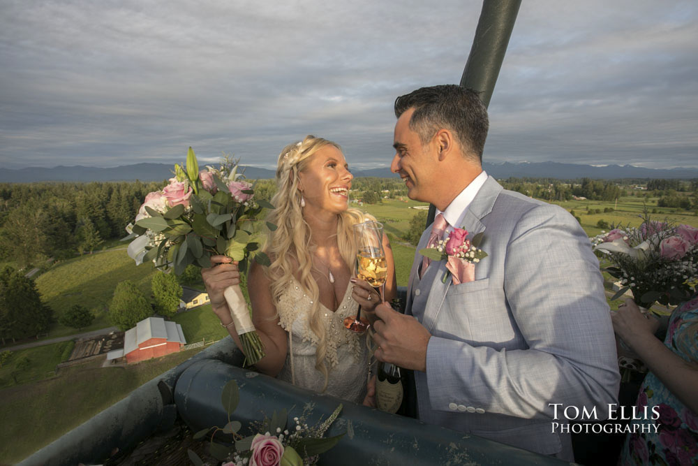 Bride and groom celebrate their elopement wedding in a hot-air balloon with a champagne toast