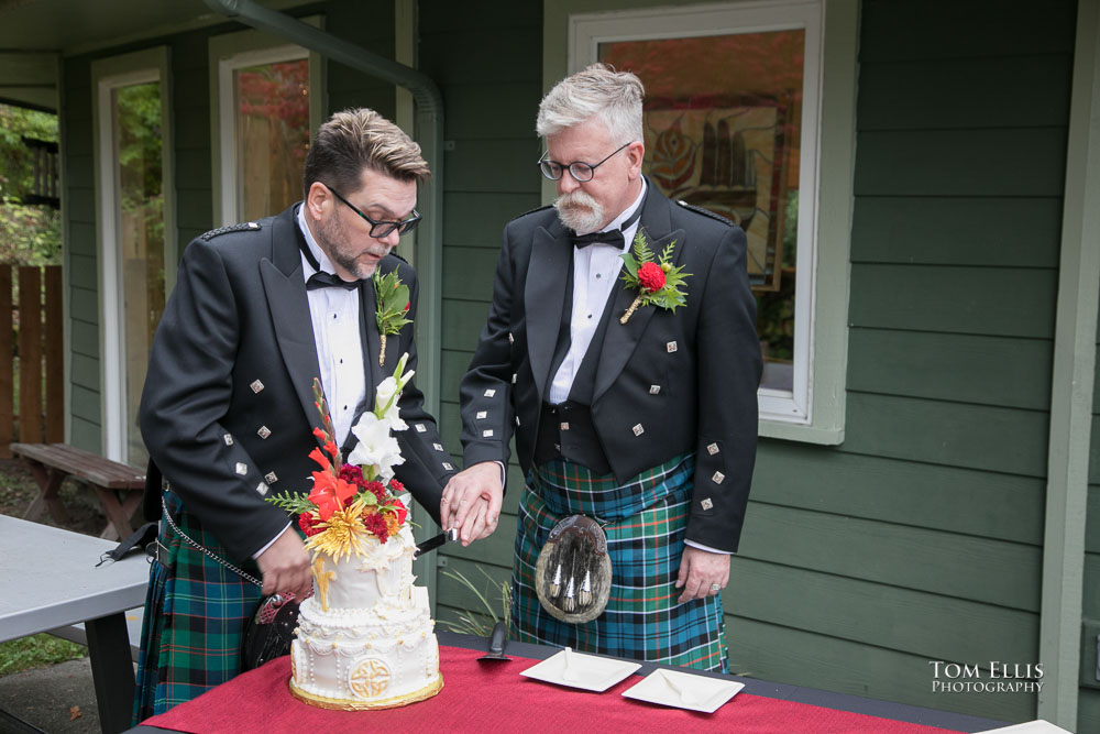 The cake cutting. Sensational Seattle same-sex LGBTQ wedding. Tom Ellis Photography, Seattle Wedding Photographer