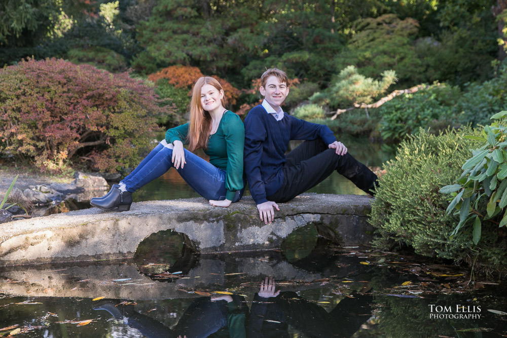 High school seniors Emma and Sean pose on a stone bridge at Seattle's Kubota Garden during their senior photo session. Tom Ellis Photography, Seattle senior photographer