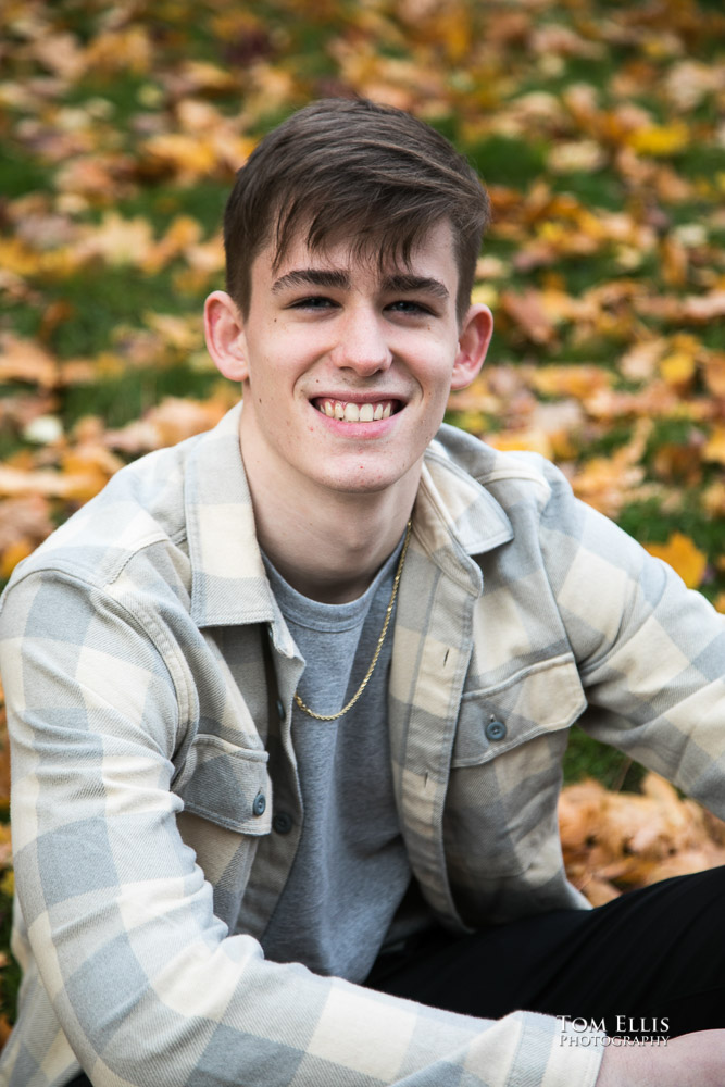 Gunnar poses for a photo among the fallen leaves during his senior photo session at the U of Washington campus. Tom Ellis Photography, Seattle senior photographer