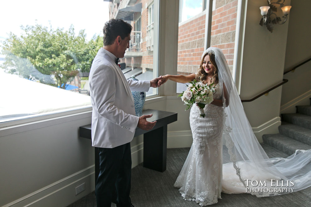 Groom Alan turns to see bride Zena during their "first look" before their wedding at the Woodmark Hotel. Tom Ellis Photography, Seattle wedding photographer