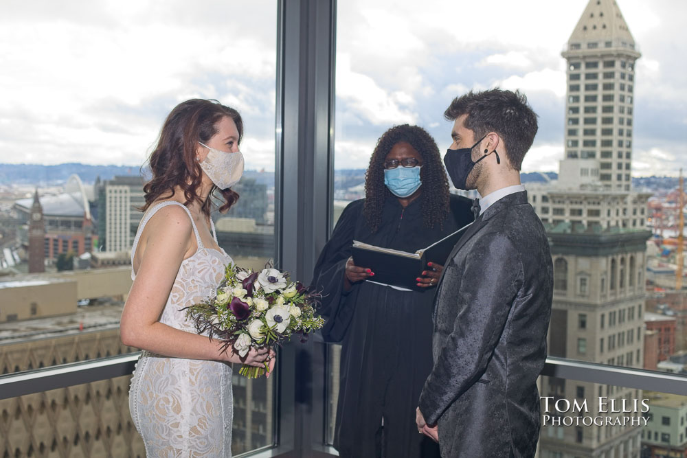Tori and Jonathon during their elopement wedding ceremony at the Seattle Municipal Courthouse. Tom Ellis Photography, Seattle wedding photographer