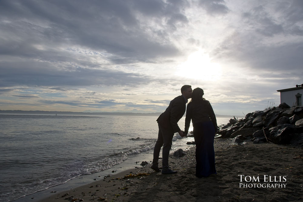 Gezeel and Dustin kiss on the beach at Discovery Park during our Seattle engagement photo session. Tom Ellis Photography, Seattle engagement photographer