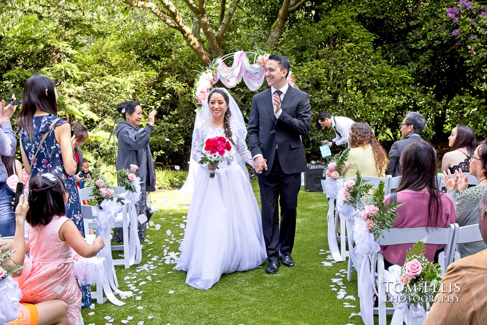 Lien and Ryan recess down the aisle at the conclusion of their Seattle area summer wedding at Robinswood House
