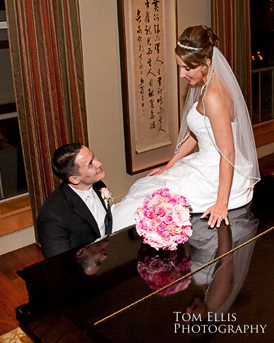 Bellevue wedding at the Hyatt Regency Hotel, bride and groom at piano with reflections.